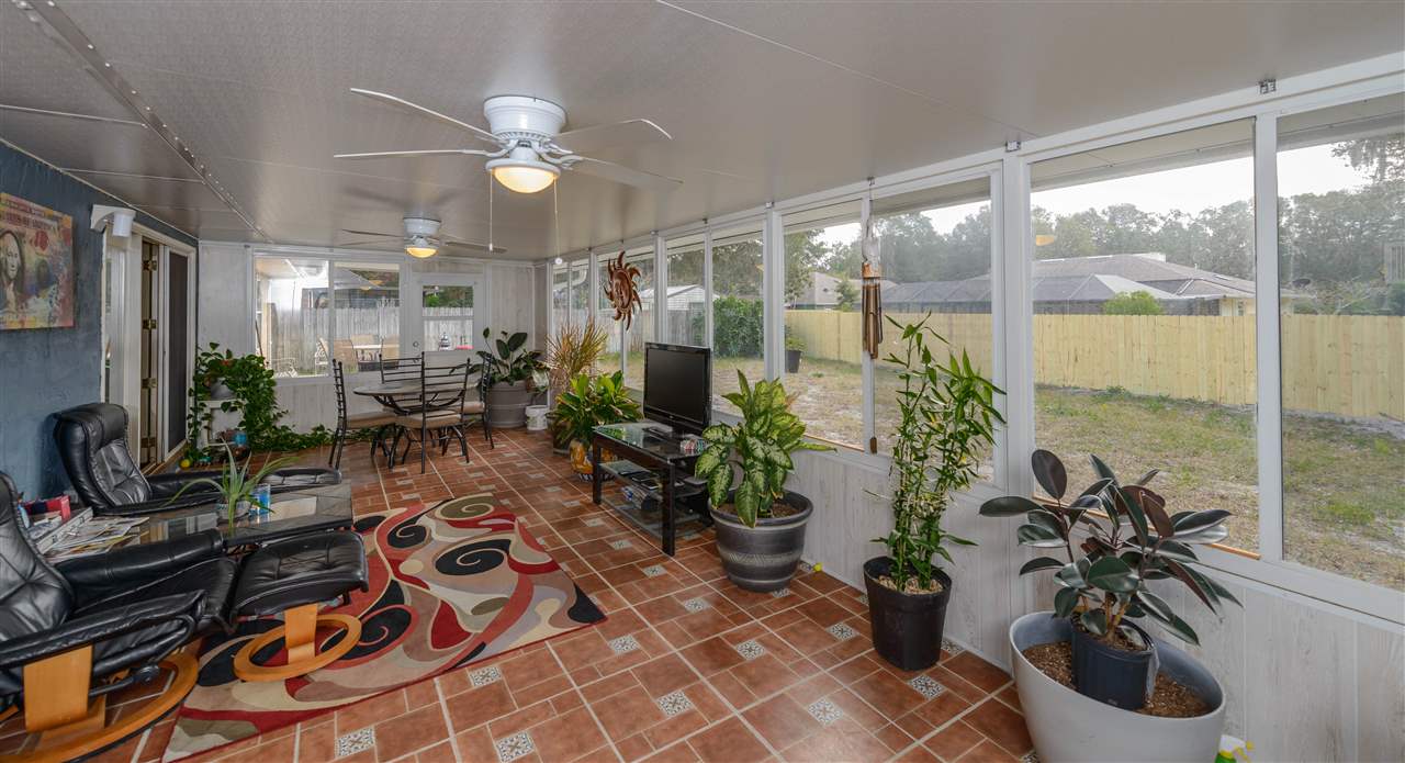 541 Moultrie Wells Road St. Augustine, FL 32086 - Photo 8 of 25 a room with potted plants and a large window