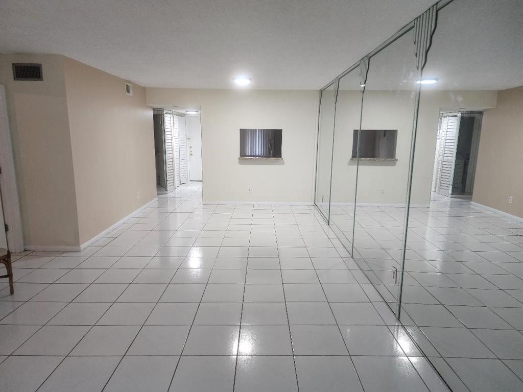 3591 Inverrary Drive, Unit 406 Lauderhill, FL 33319 - Photo 11 of 13 a view of a livingroom with an empty space and window