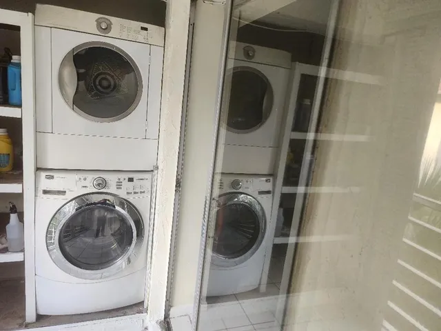 a view of a hallway with washer and dryer