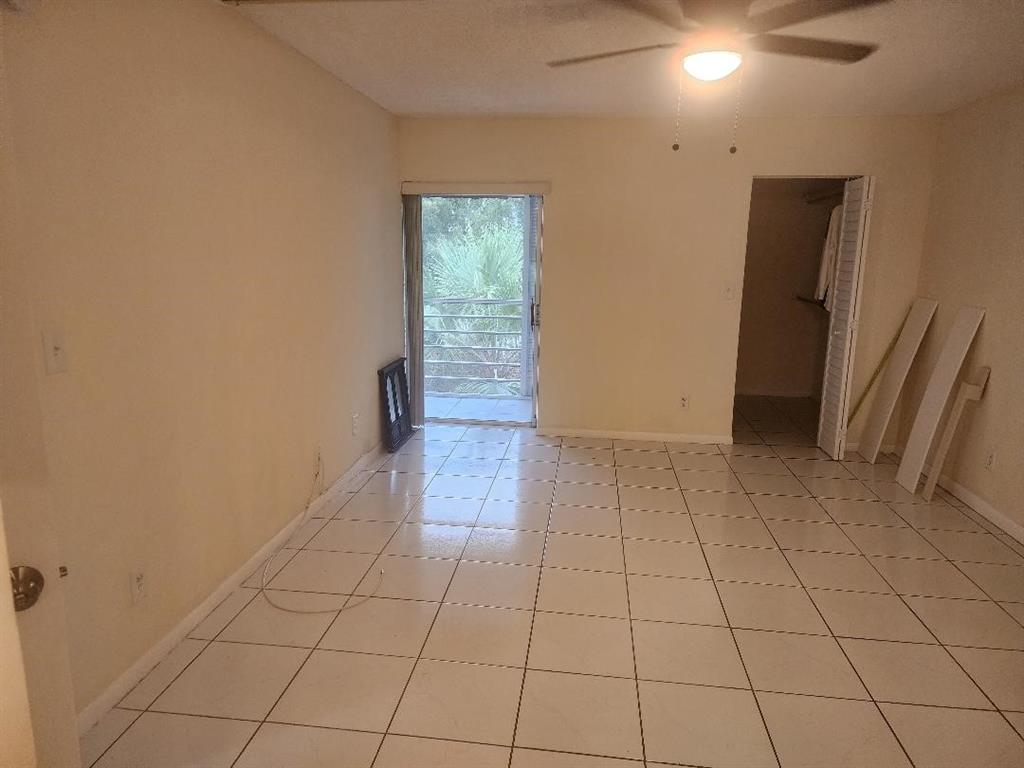 3591 Inverrary Drive, Unit 406 Lauderhill, FL 33319 - Photo 6 of 13 an empty room with wooden floor and natural light