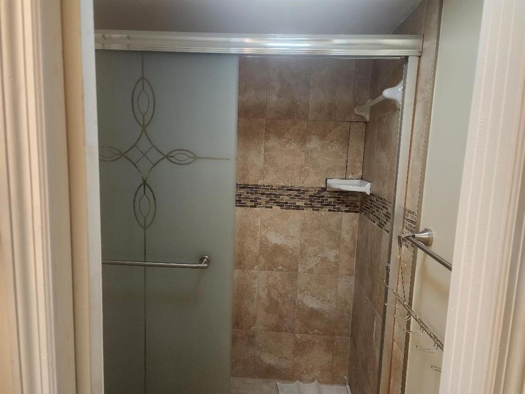 3591 Inverrary Drive, Unit 406 Lauderhill, FL 33319 - Photo 8 of 13 a bathroom with a glass shower door