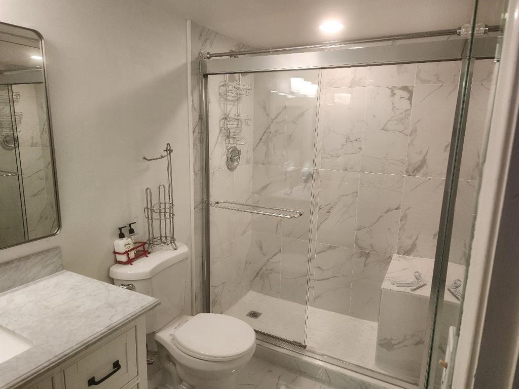 3591 Inverrary Drive, Unit 406 Lauderhill, FL 33319 - Photo 10 of 13 a bathroom with a sink a toilet and shower