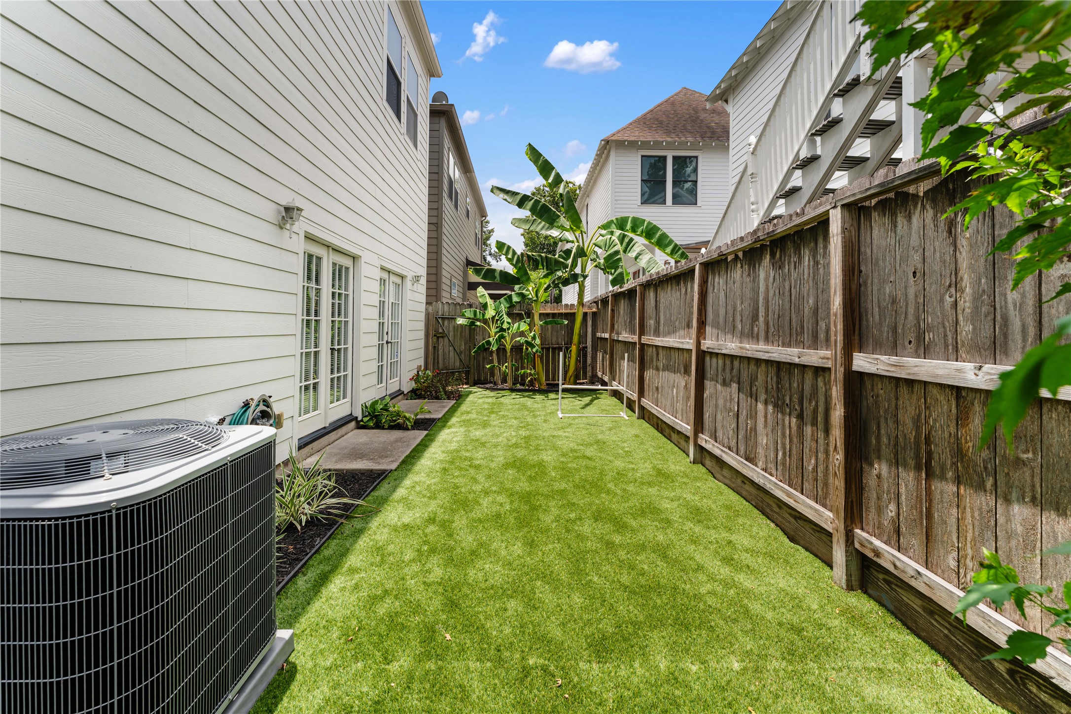 415 West 8th Street Houston, TX 77007 - Photo 19 of 39 Enjoy a surprisingly spacious, fully fenced backyard featuring low-maintenance artificial turf, mature tropical landscaping, and plenty of room for pets, play, or outdoor entertaining. A rare outdoor retreat in this highly sought-after Heights location.