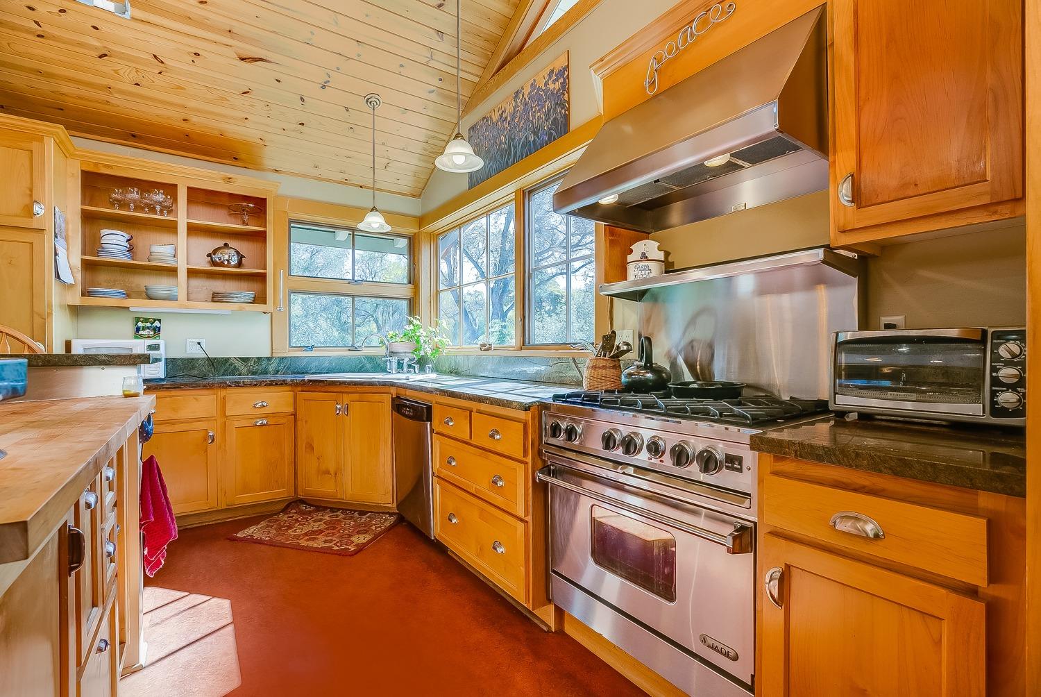 407 Del Norte Road Ojai, CA 93023 - Photo 16 of 39 a kitchen with stainless steel appliances granite countertop a stove a sink and a microwave