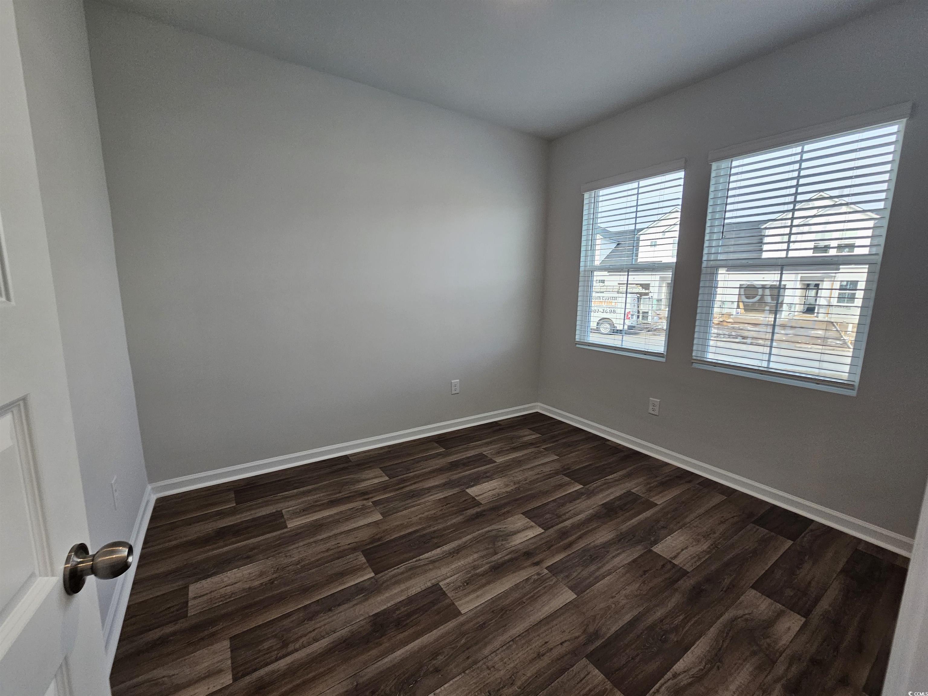 2100 Wild Indigo Circle Calabash, NC 28467 - Photo 11 of 31 Spare room with dark wood-style floors and baseboards