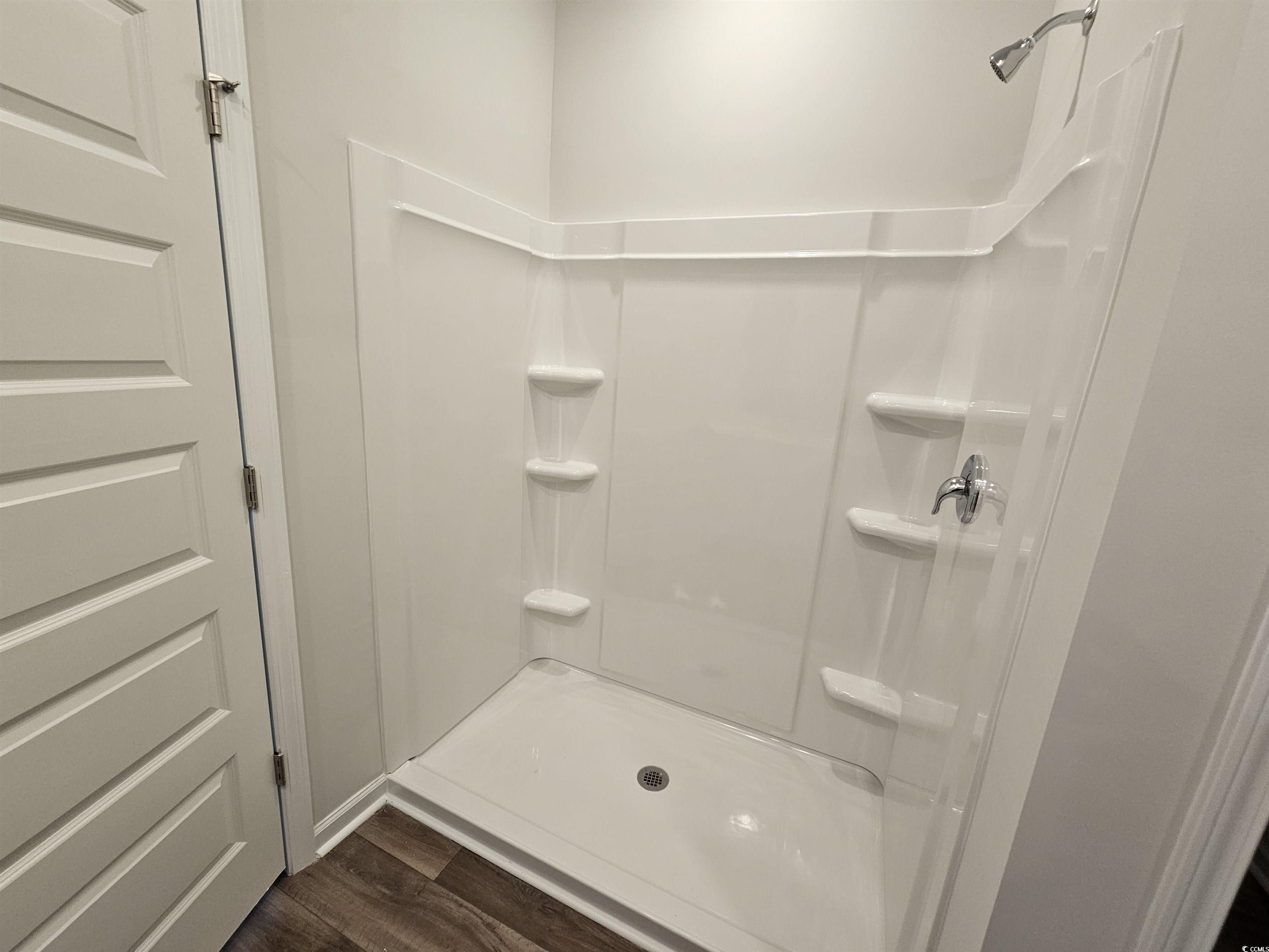 2100 Wild Indigo Circle Calabash, NC 28467 - Photo 19 of 31 Bathroom with a shower stall and dark wood finished floors