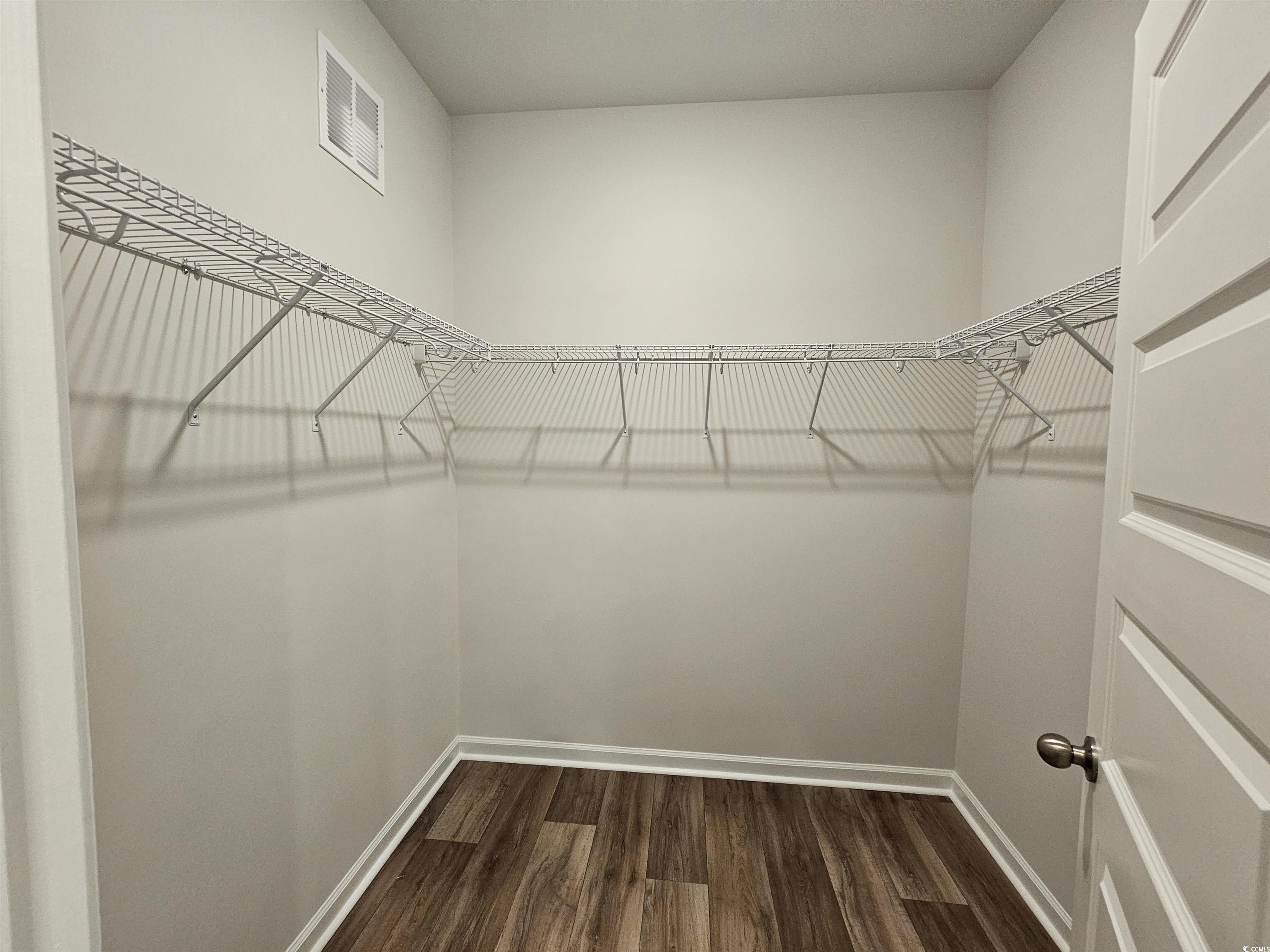 2100 Wild Indigo Circle Calabash, NC 28467 - Photo 20 of 31 Spacious closet featuring dark wood-style floors