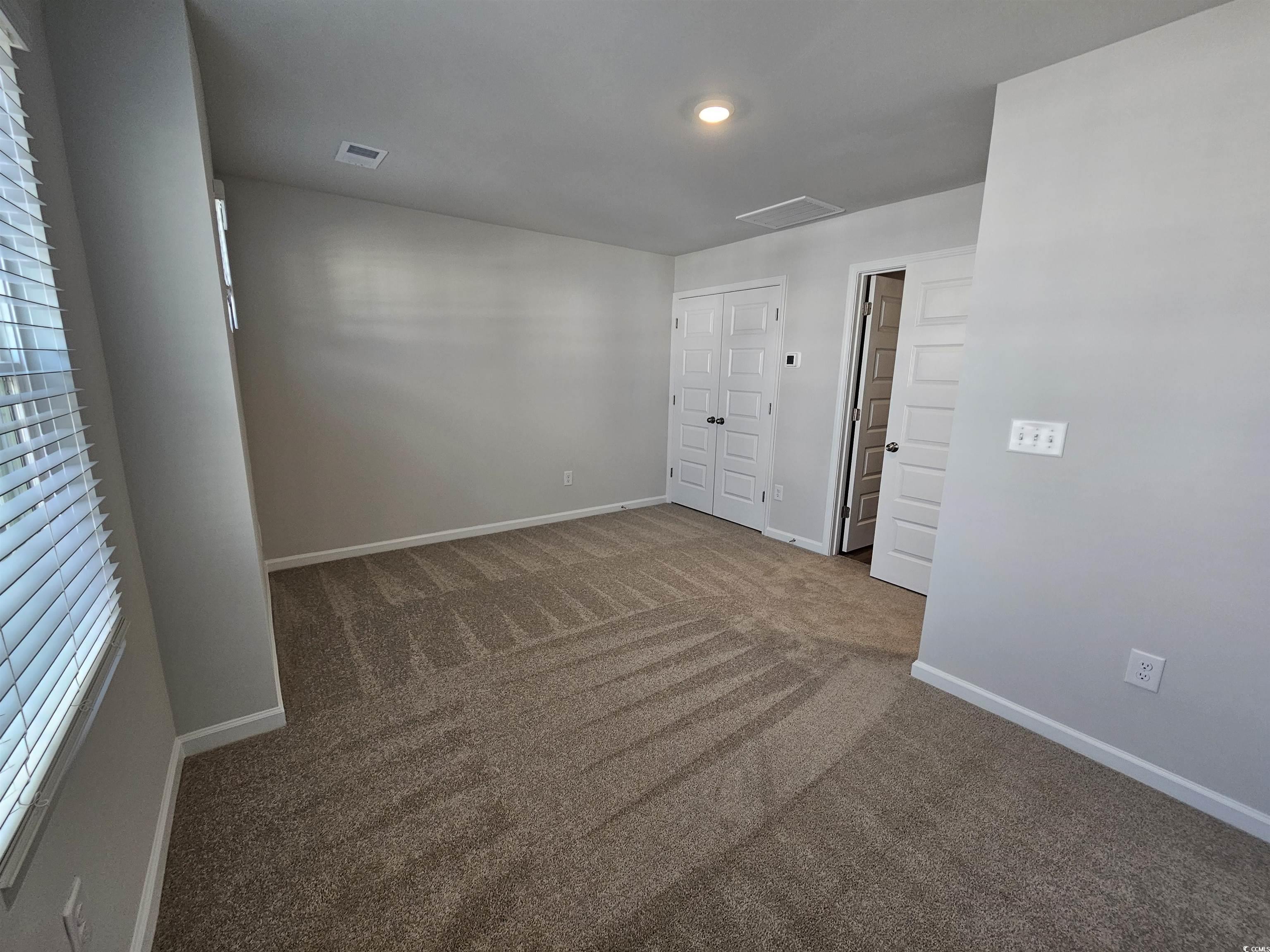 2100 Wild Indigo Circle Calabash, NC 28467 - Photo 23 of 31 Carpeted spare room featuring baseboards