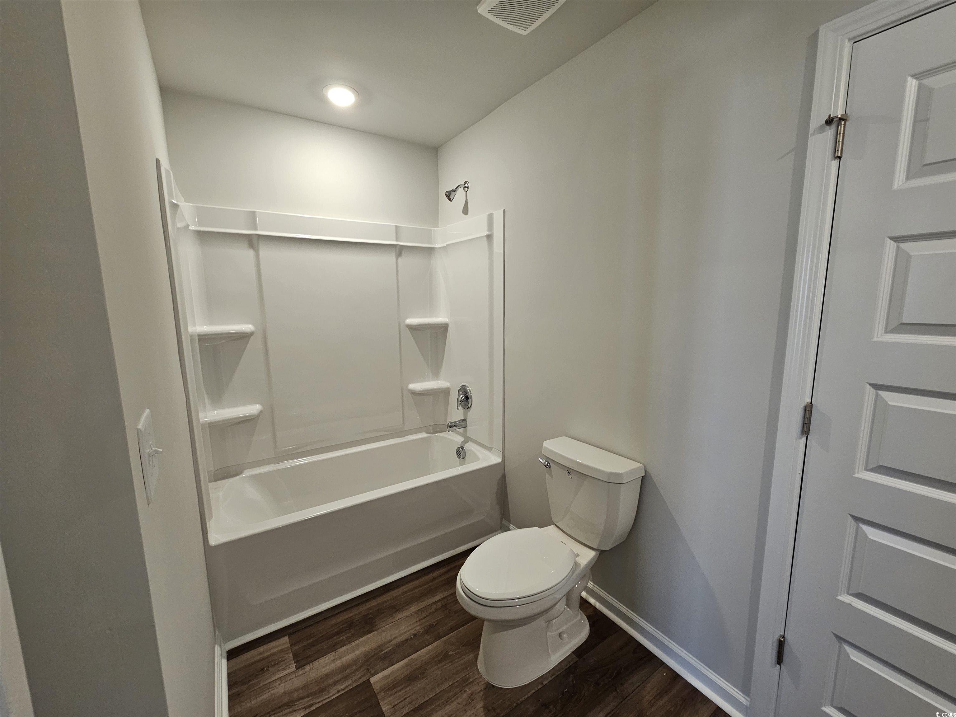 2100 Wild Indigo Circle Calabash, NC 28467 - Photo 27 of 31 Full bathroom featuring dark wood-type flooring and shower / washtub combination