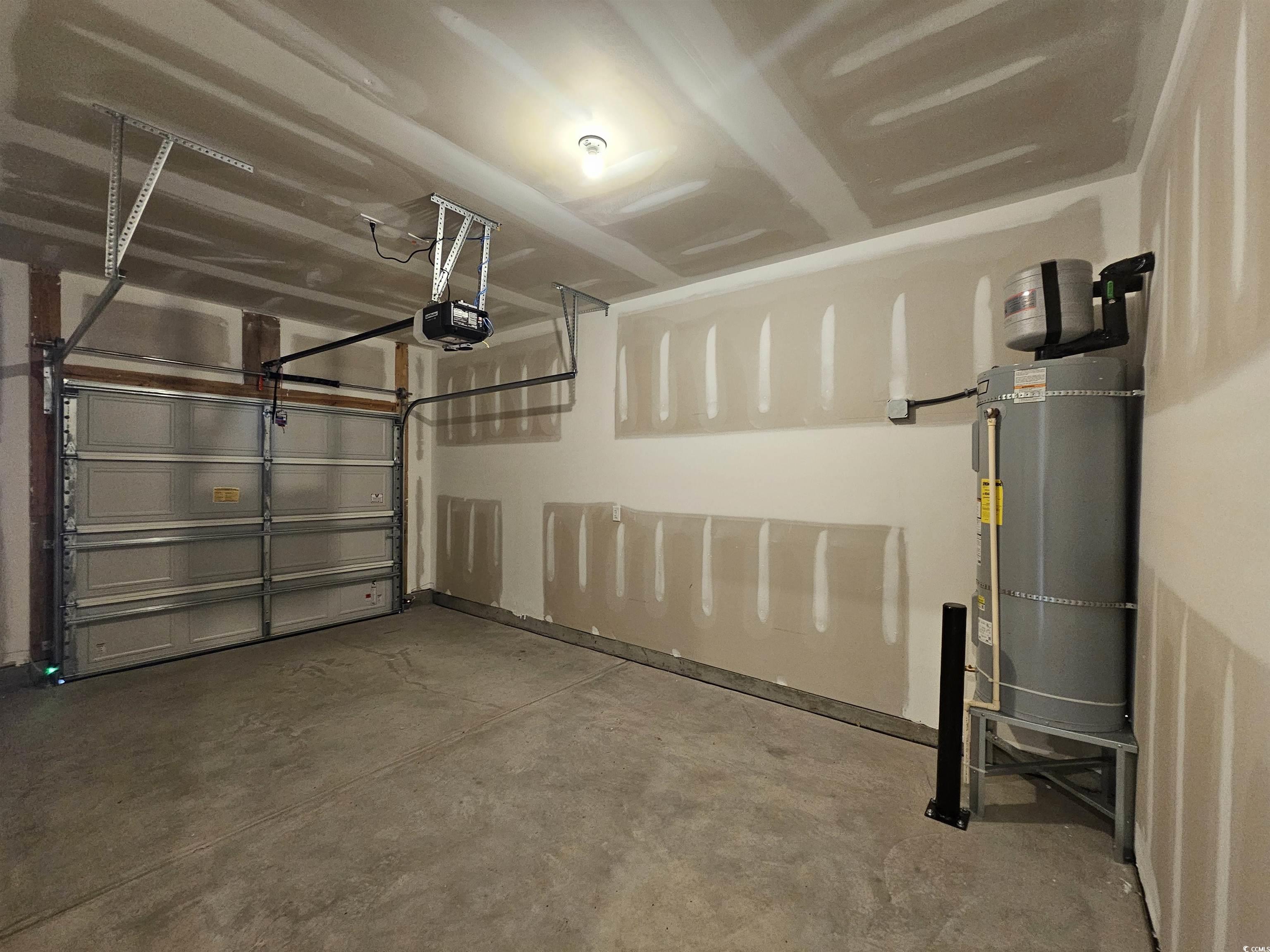 2100 Wild Indigo Circle Calabash, NC 28467 - Photo 30 of 31 Garage featuring water heater and a garage door opener