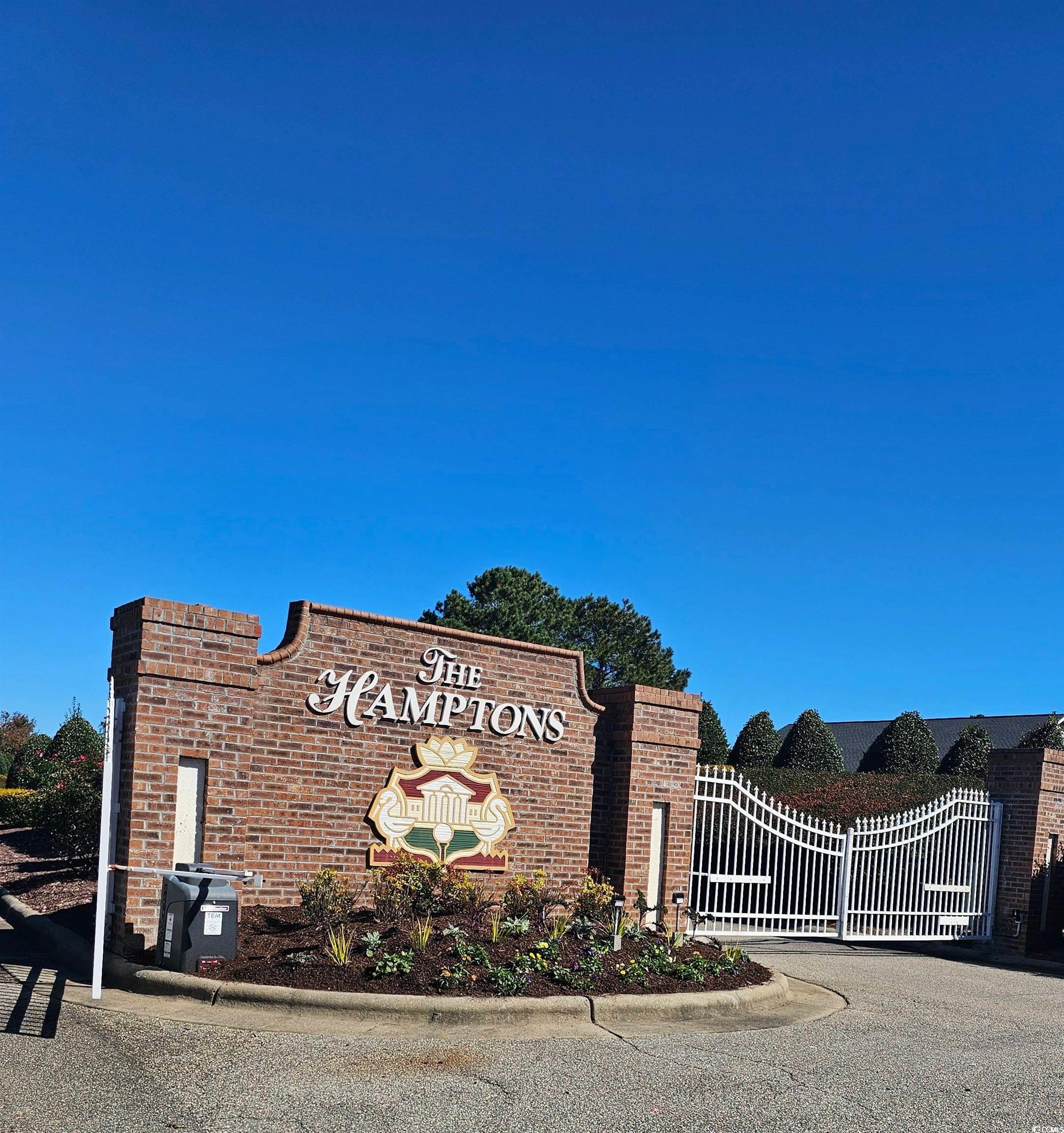 2100 Wild Indigo Circle Calabash, NC 28467 - Photo 3 of 31 Community / neighborhood sign with a gate
