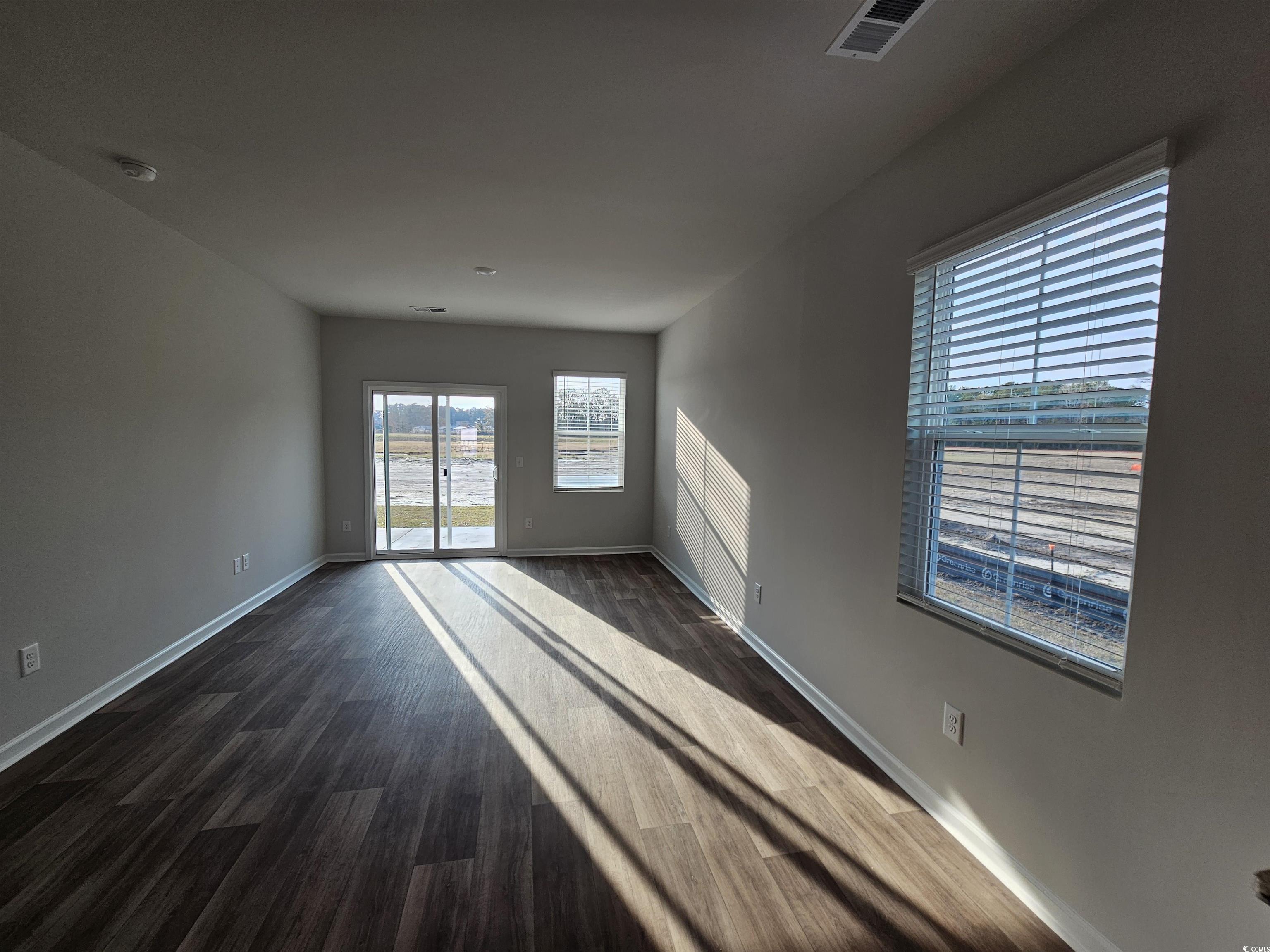 2100 Wild Indigo Circle Calabash, NC 28467 - Photo 9 of 31 Unfurnished room with dark wood-style flooring and baseboards