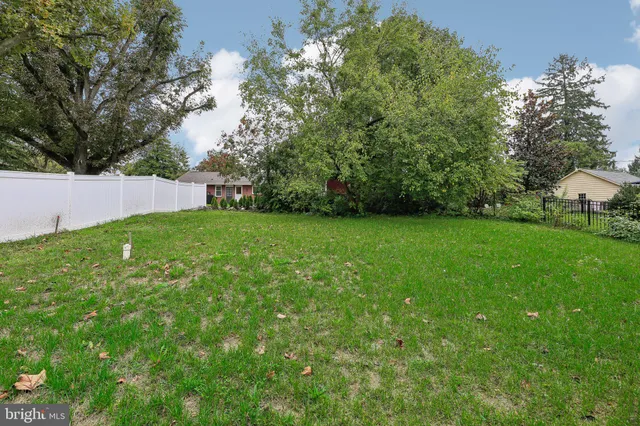 a view of a field of grass and trees
