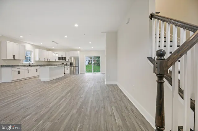a view of a kitchen with wooden floor and electronic appliances