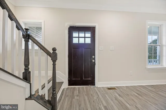 a view of an entryway with wooden floor and stairs