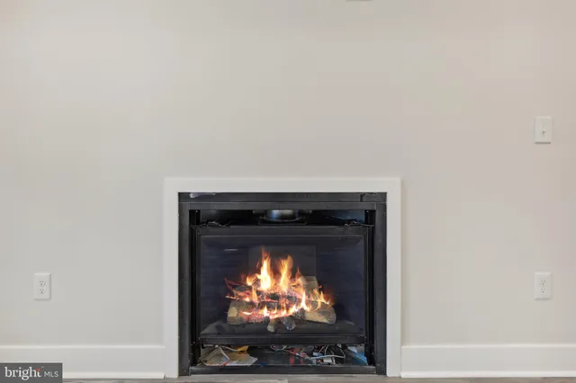 a living room with a fireplace and a flat screen tv