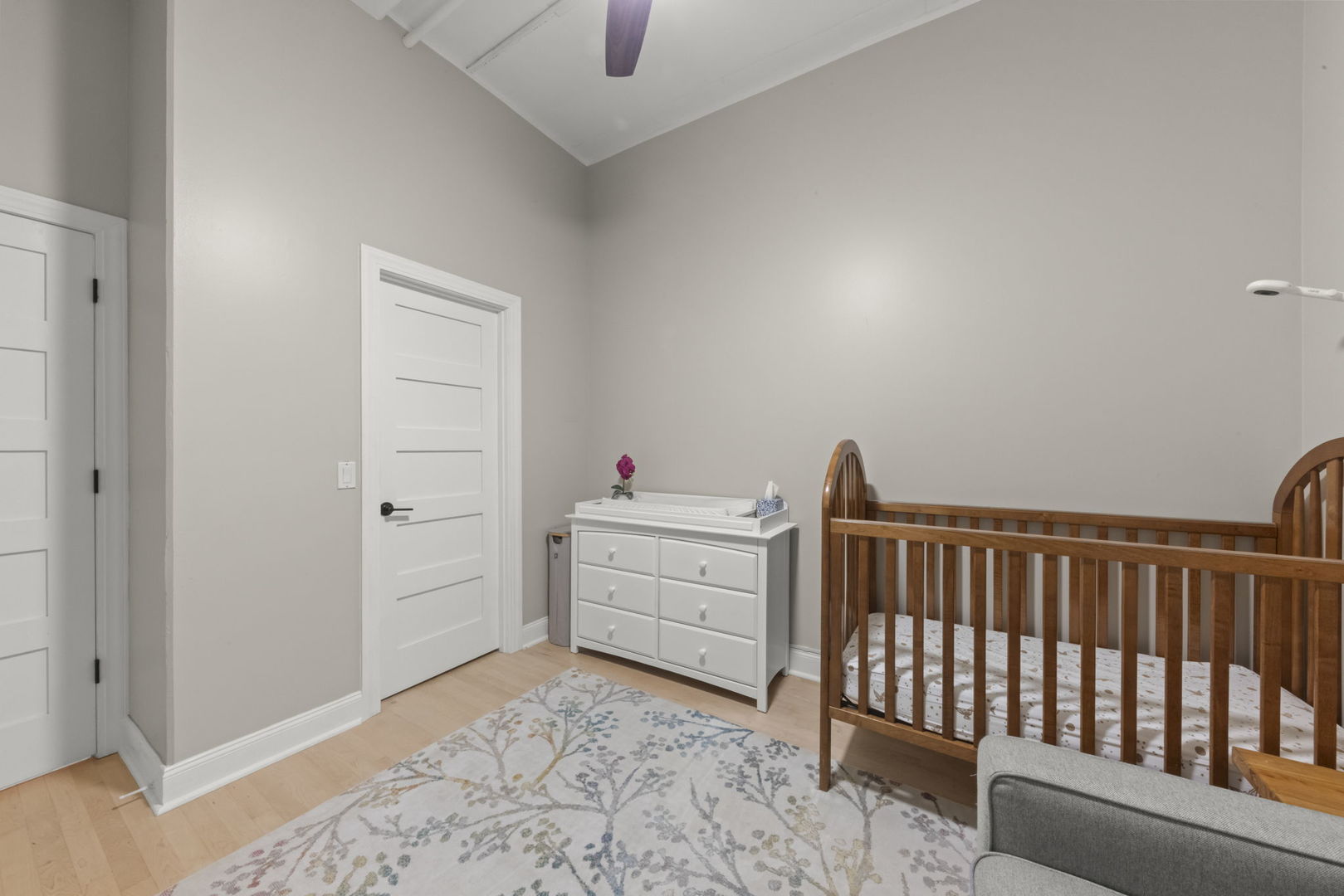 1301 West Madison Street, Unit 305 Chicago, IL 60607 - Photo 16 of 22 a bedroom with a bed and wooden floor