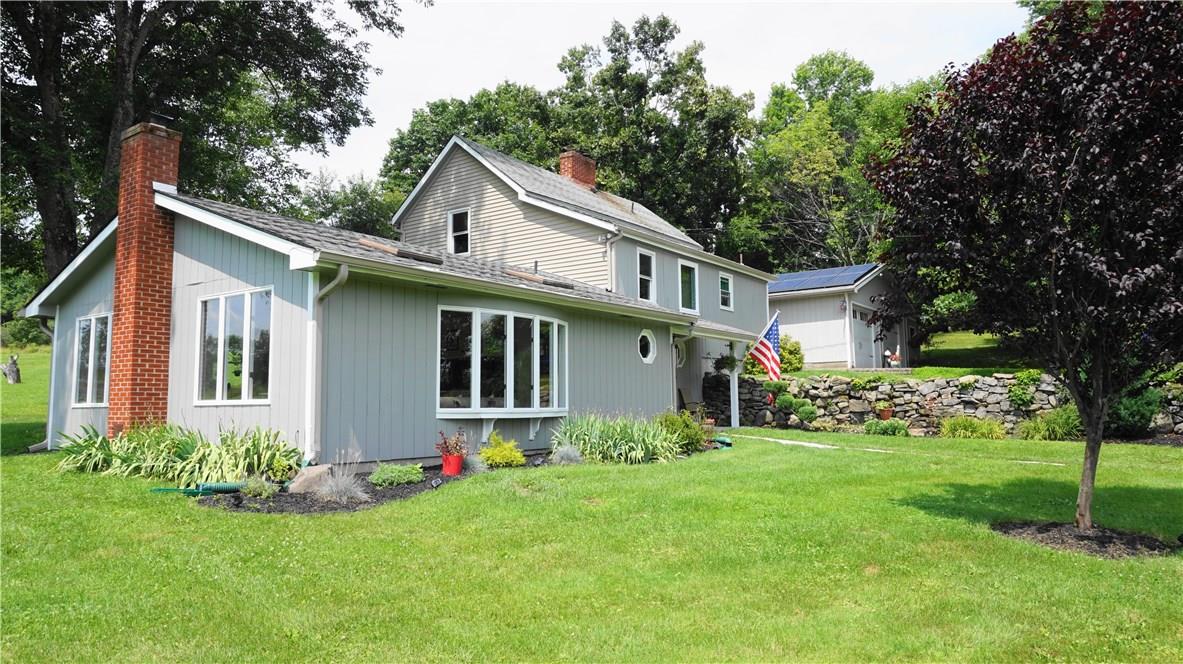 a front view of house with yard and green space