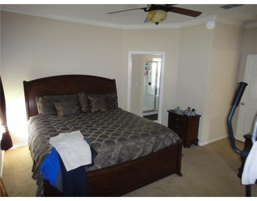 312 San Rafael Drive Portland, TX 78374 - Photo 8 of 10 a bedroom with a bed and wooden floor