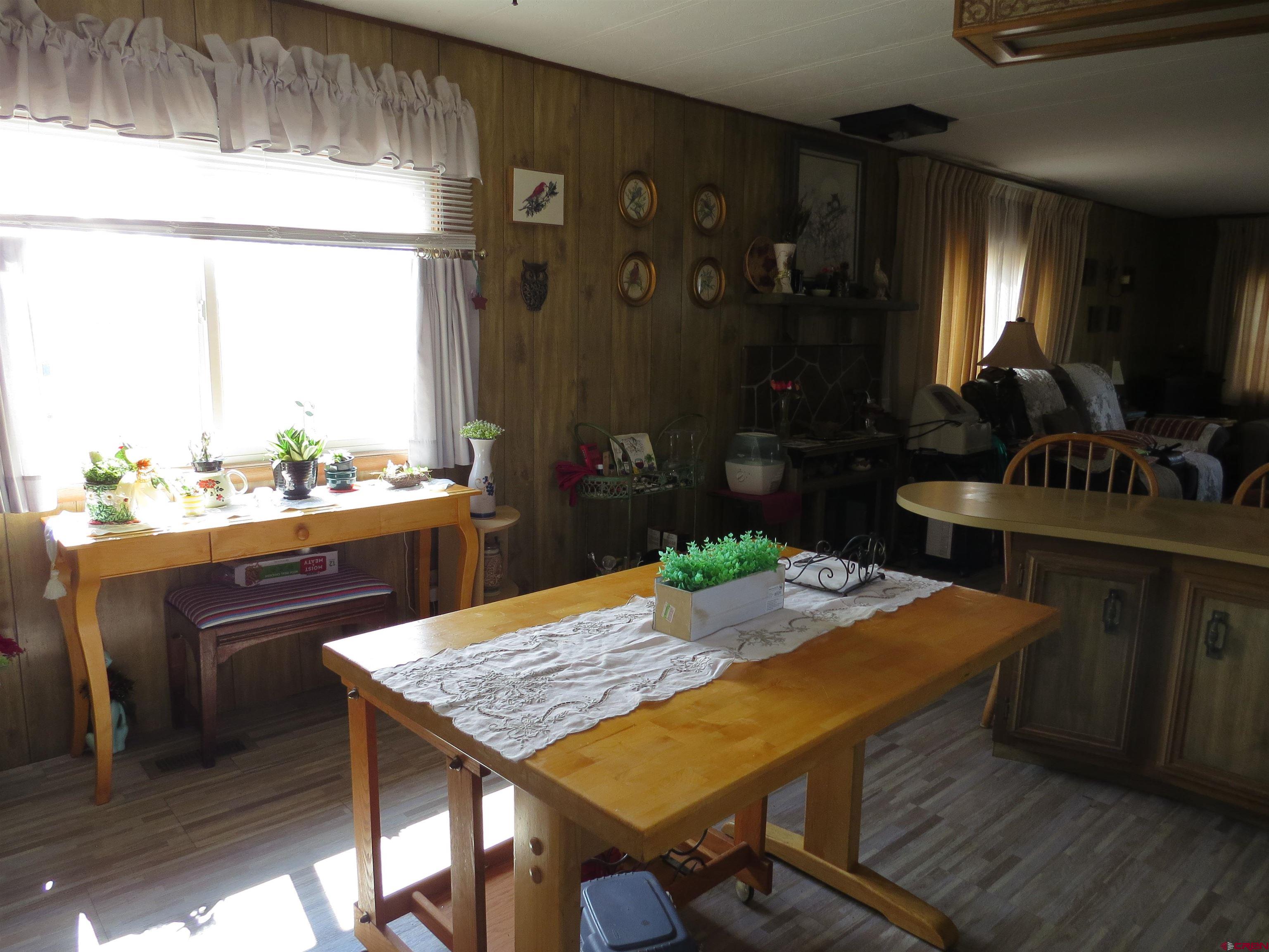 20028 Justice Road Austin, CO 81410 - Photo 11 of 22 a dining room with furniture and window