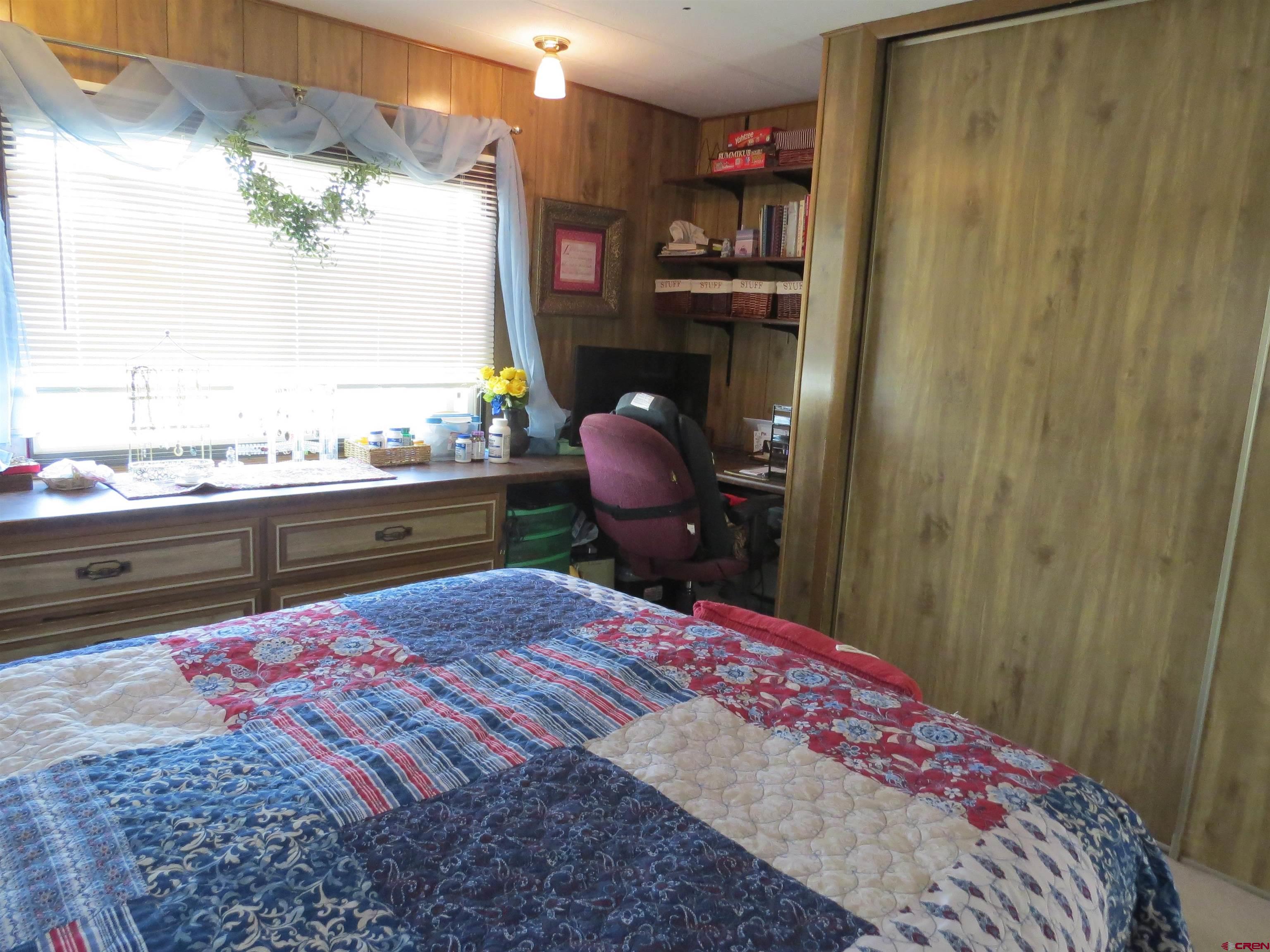 20028 Justice Road Austin, CO 81410 - Photo 13 of 22 a bed room with a bed and chair