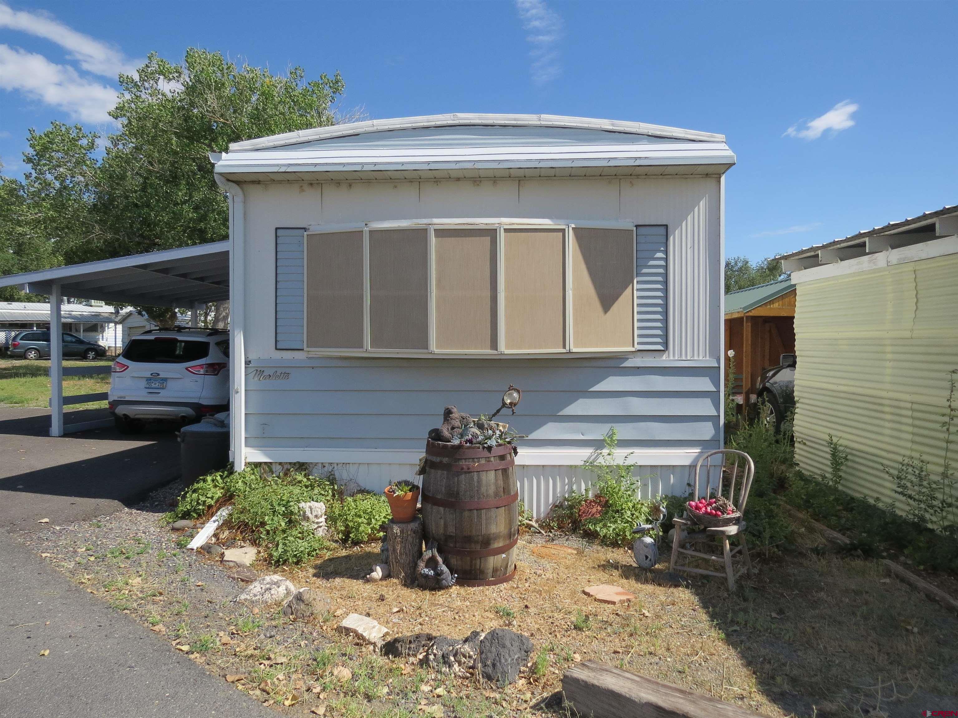 20028 Justice Road Austin, CO 81410 - Photo 18 of 22 a front view of a house with garden