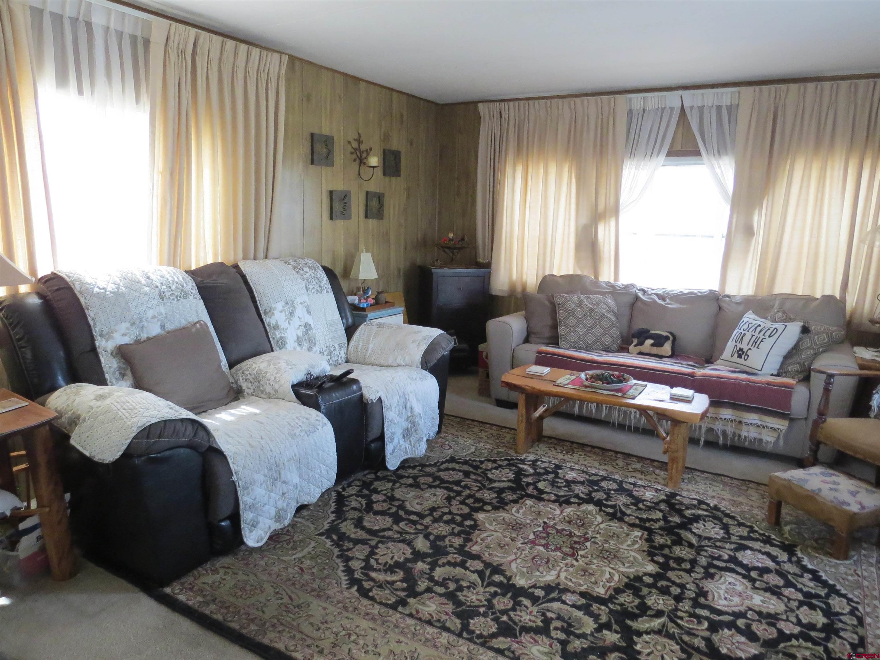 20028 Justice Road Austin, CO 81410 - Photo 2 of 22 a living room with furniture and a large window