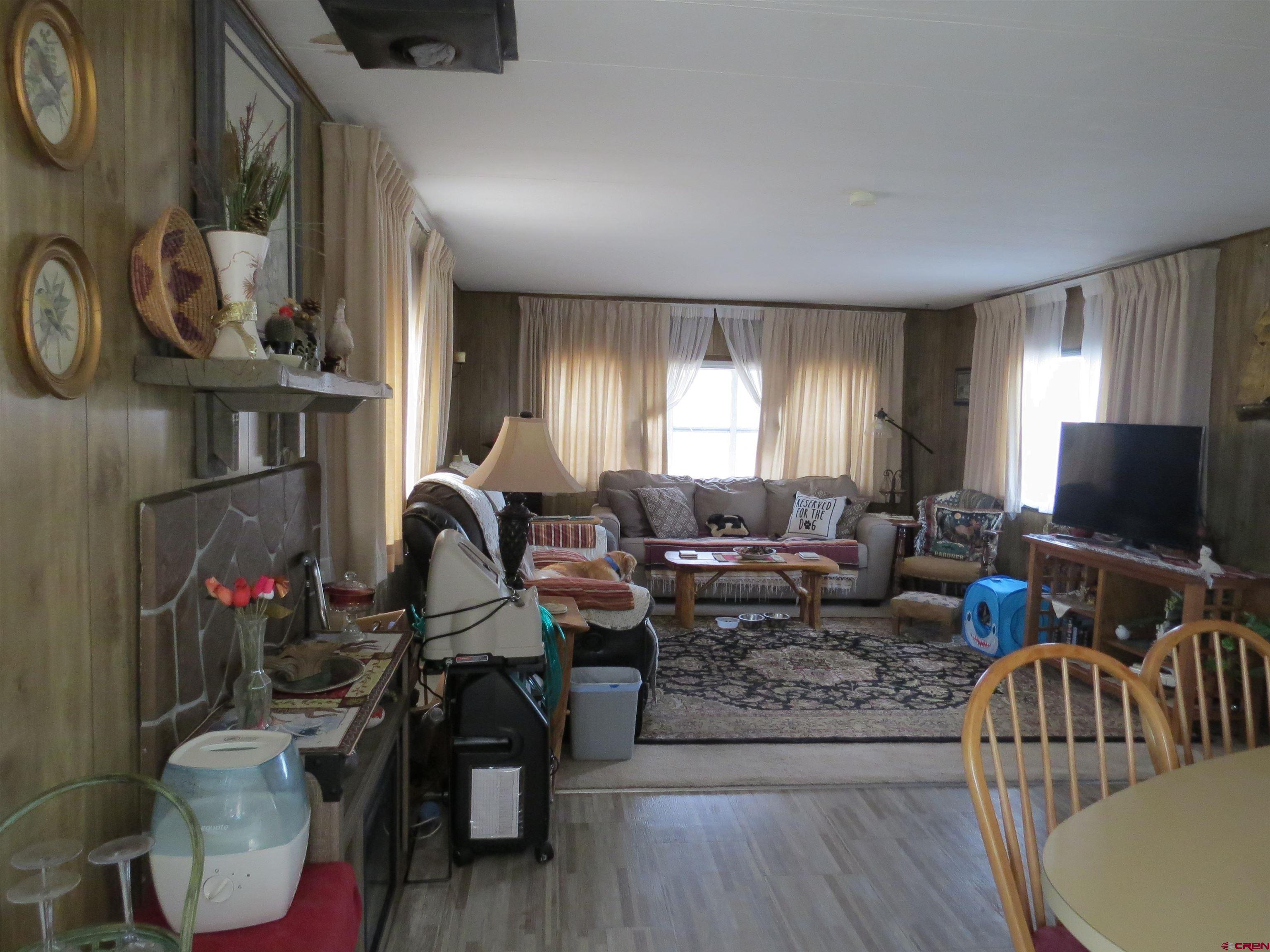 20028 Justice Road Austin, CO 81410 - Photo 4 of 22 a living room with furniture a flat screen tv and a window