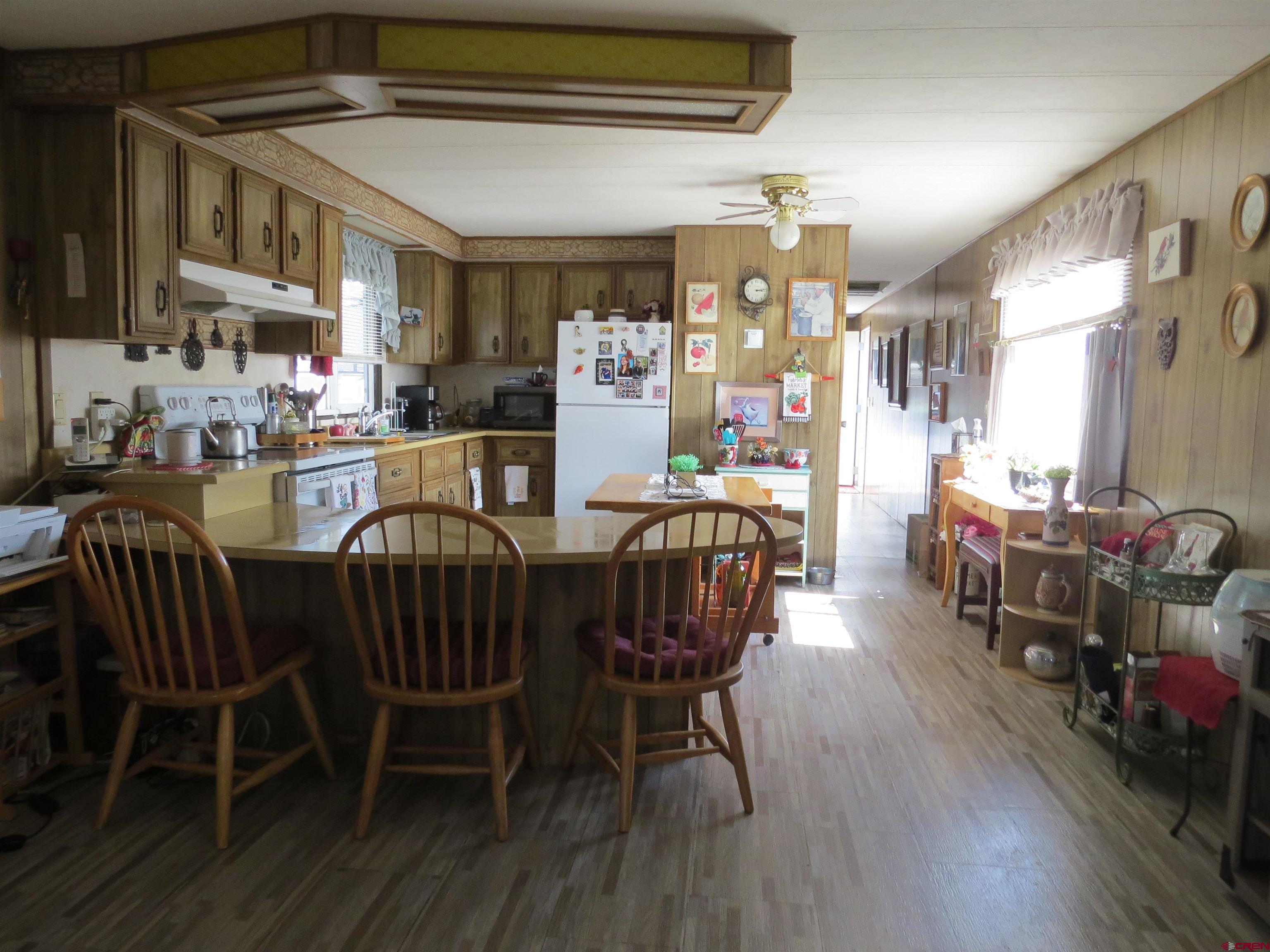 20028 Justice Road Austin, CO 81410 - Photo 6 of 22 a view of a dining room with furniture and wooden floor