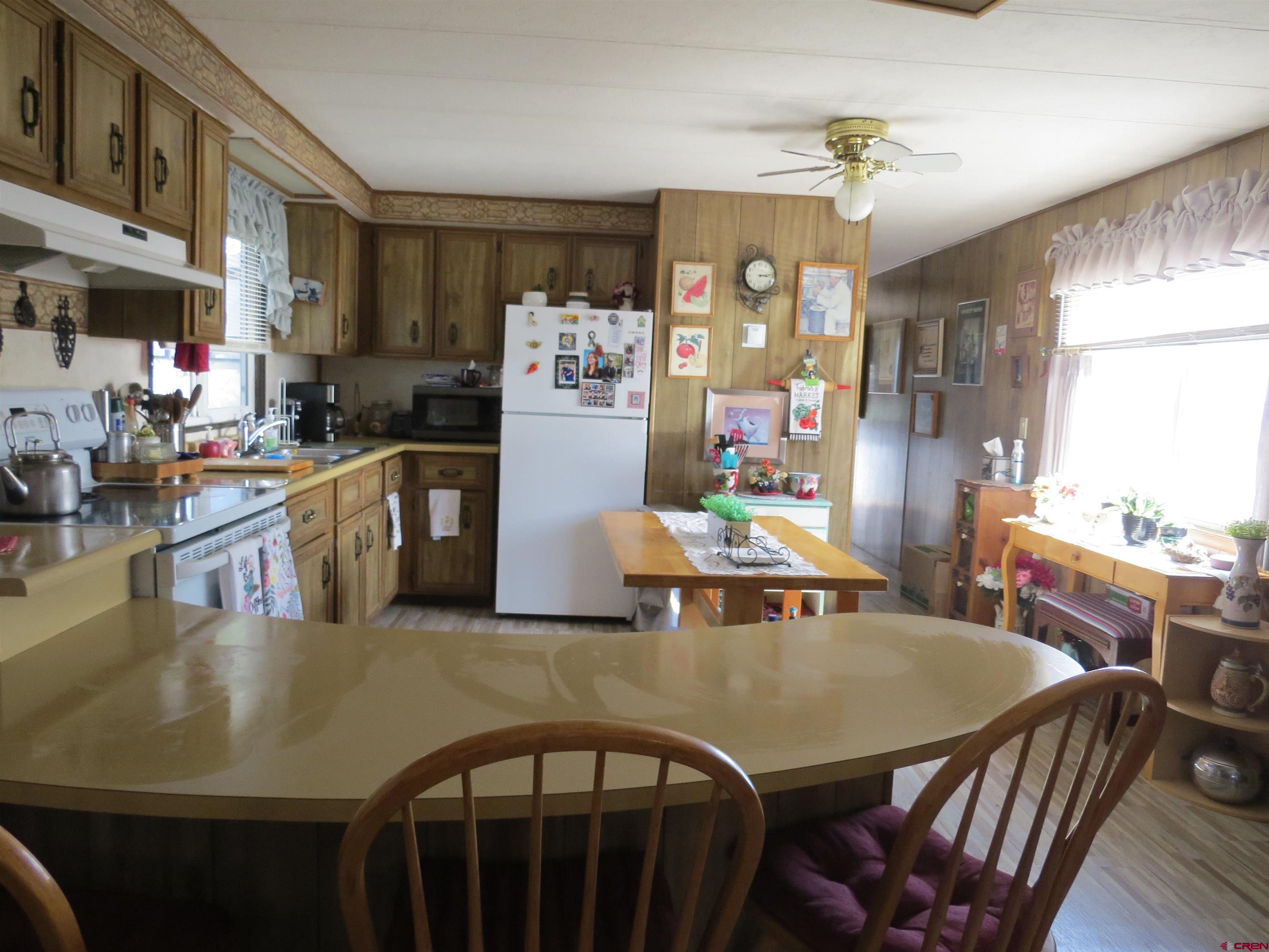 20028 Justice Road Austin, CO 81410 - Photo 7 of 22 a view of a dining room with furniture and a chandelier