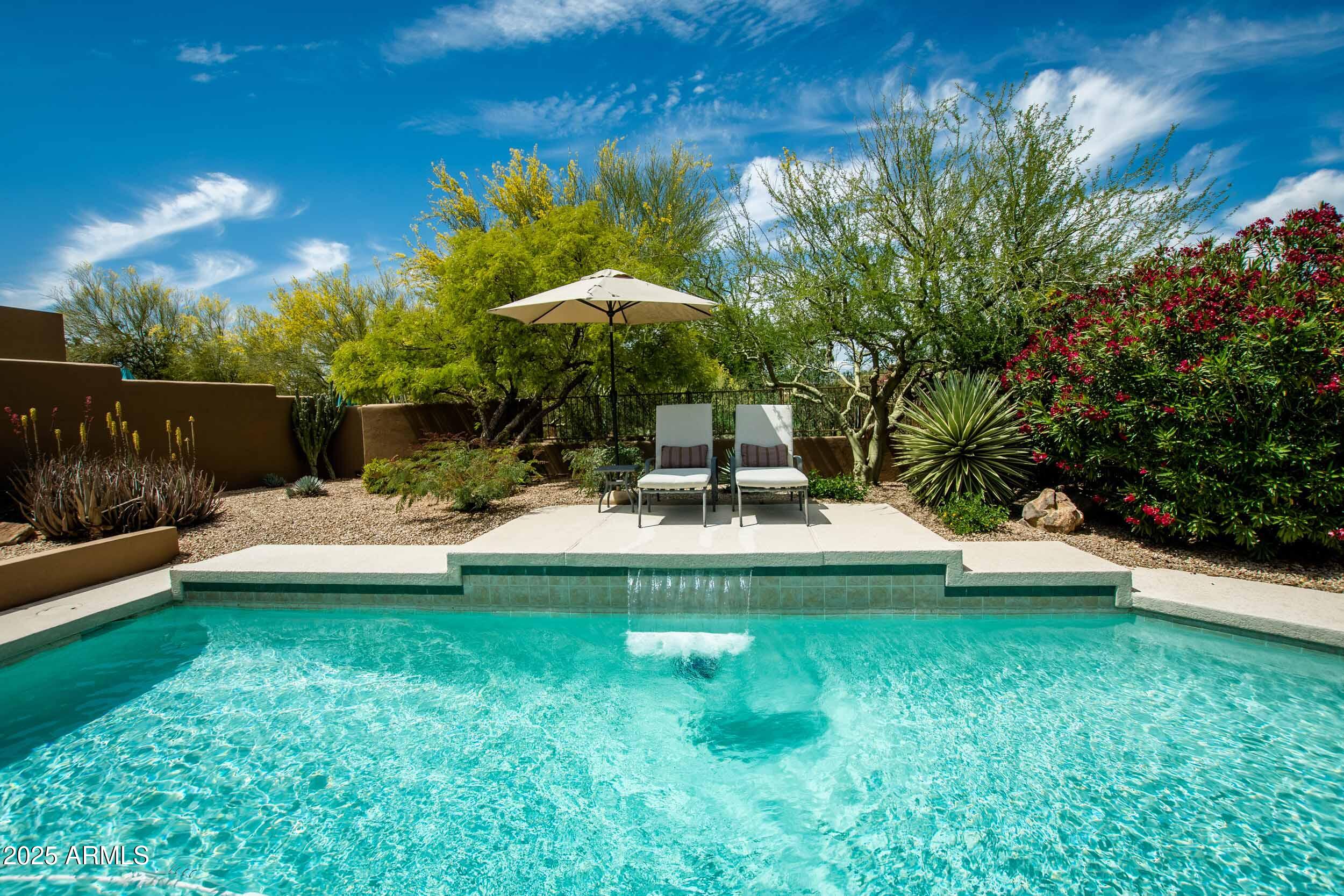 8502 East Cave Creek Road, Unit 61 Carefree, AZ 85377 - Photo 2 of 52 a swimming pool with outdoor seating and yard