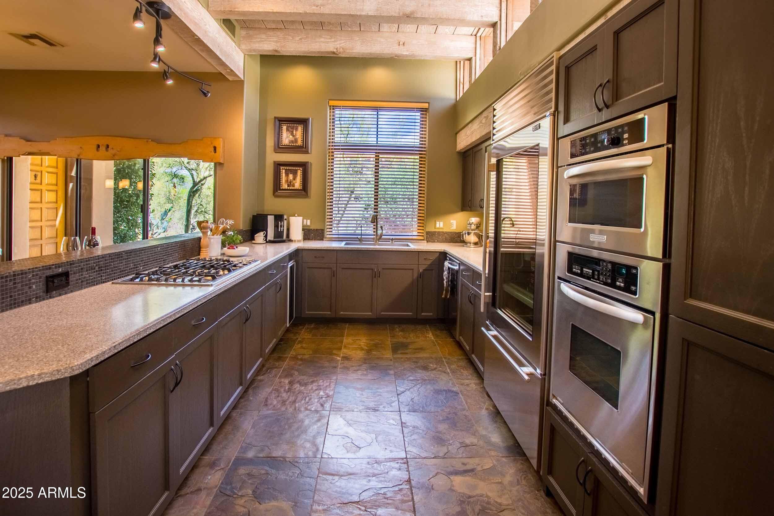 8502 East Cave Creek Road, Unit 61 Carefree, AZ 85377 - Photo 21 of 52 a large kitchen with a sink and washing machine