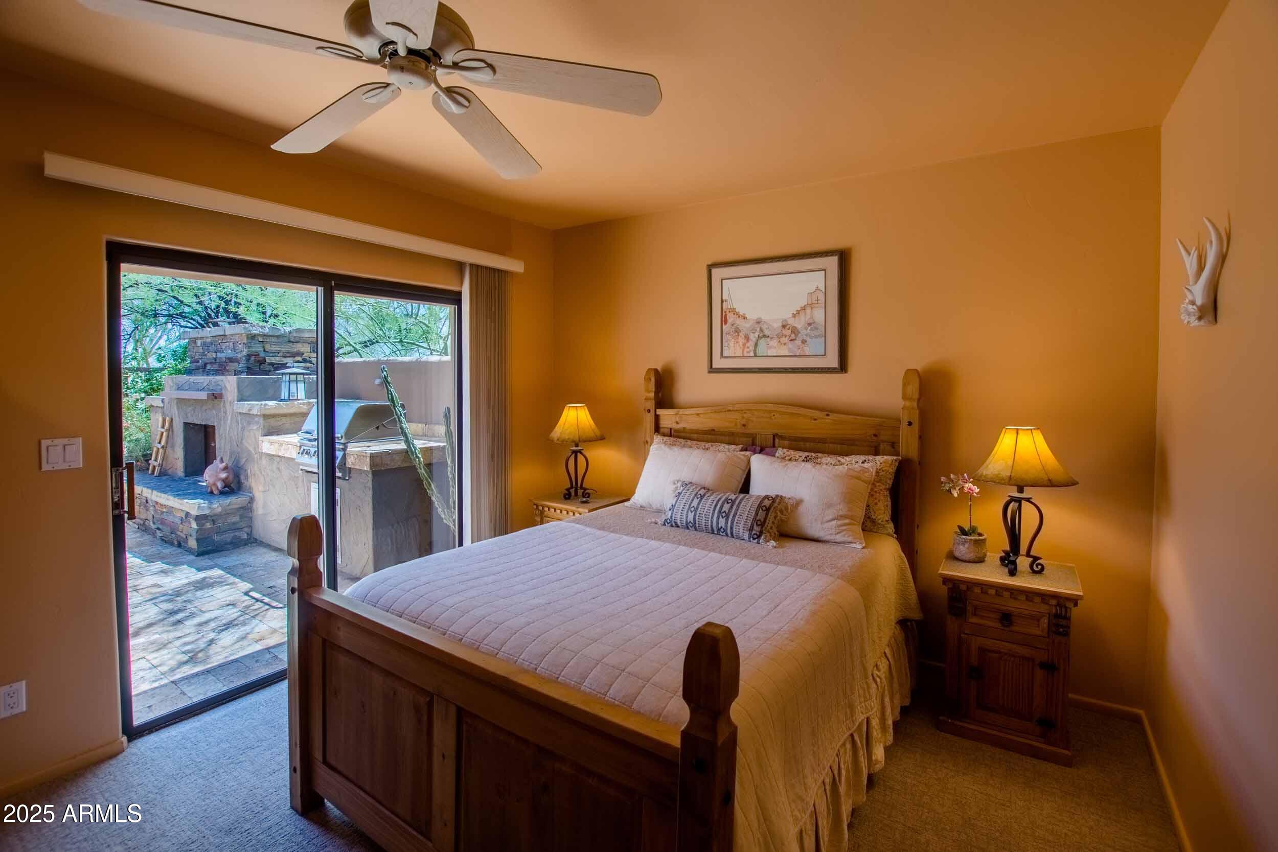 8502 East Cave Creek Road, Unit 61 Carefree, AZ 85377 - Photo 27 of 52 a bedroom with a bed and wooden floor