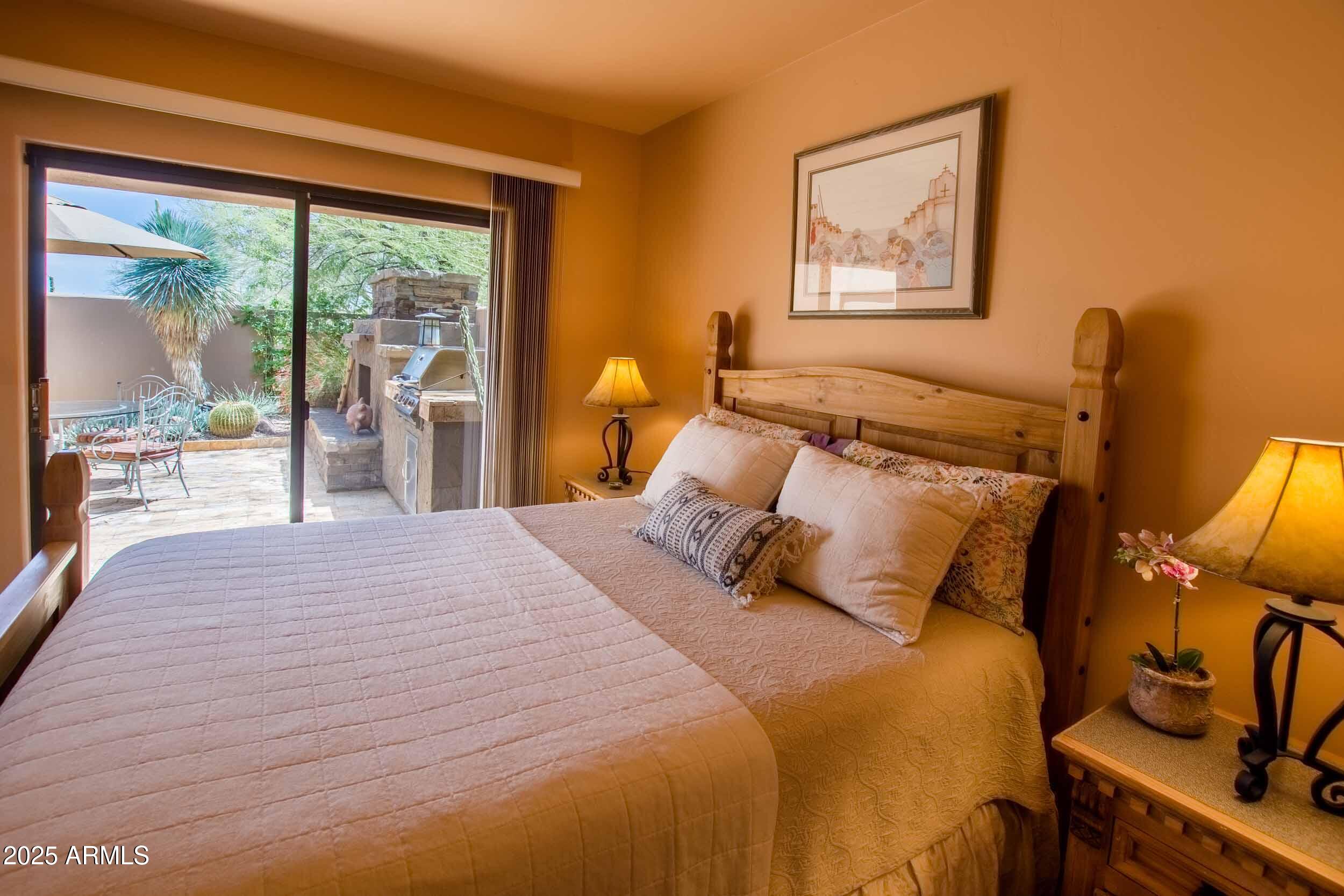 8502 East Cave Creek Road, Unit 61 Carefree, AZ 85377 - Photo 28 of 52 a bedroom with a bed and wooden floor