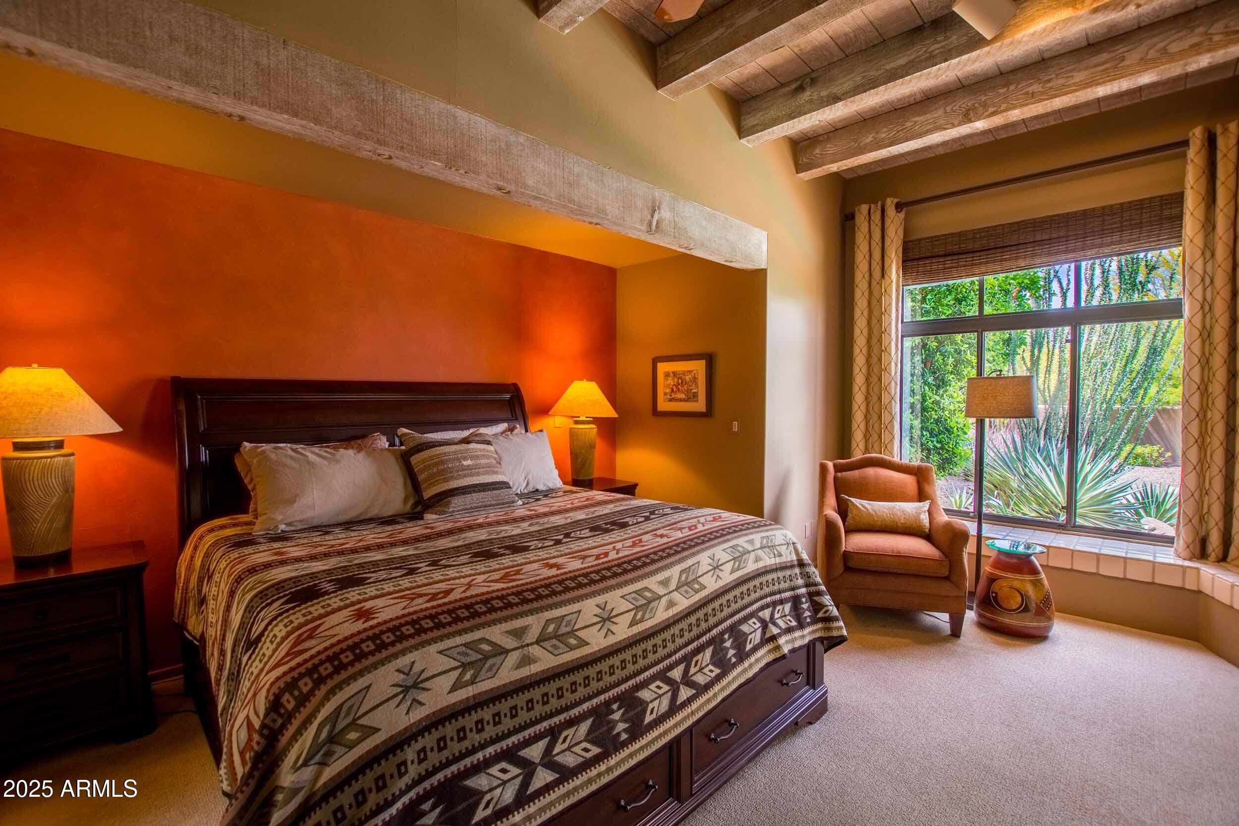 8502 East Cave Creek Road, Unit 61 Carefree, AZ 85377 - Photo 29 of 52 a bedroom with a bed and a couch with outer view