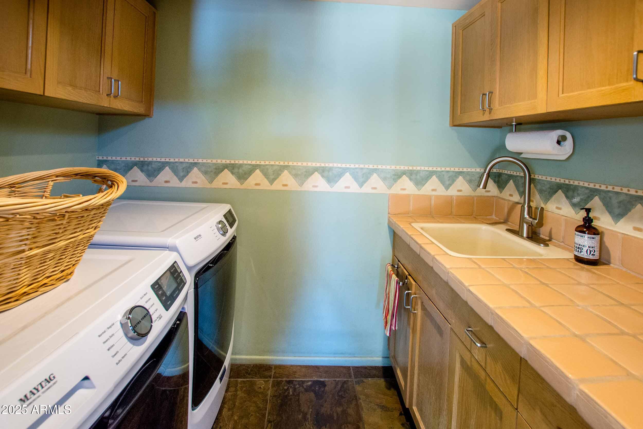 8502 East Cave Creek Road, Unit 61 Carefree, AZ 85377 - Photo 49 of 52 a utility room with a sink a washer and dryer