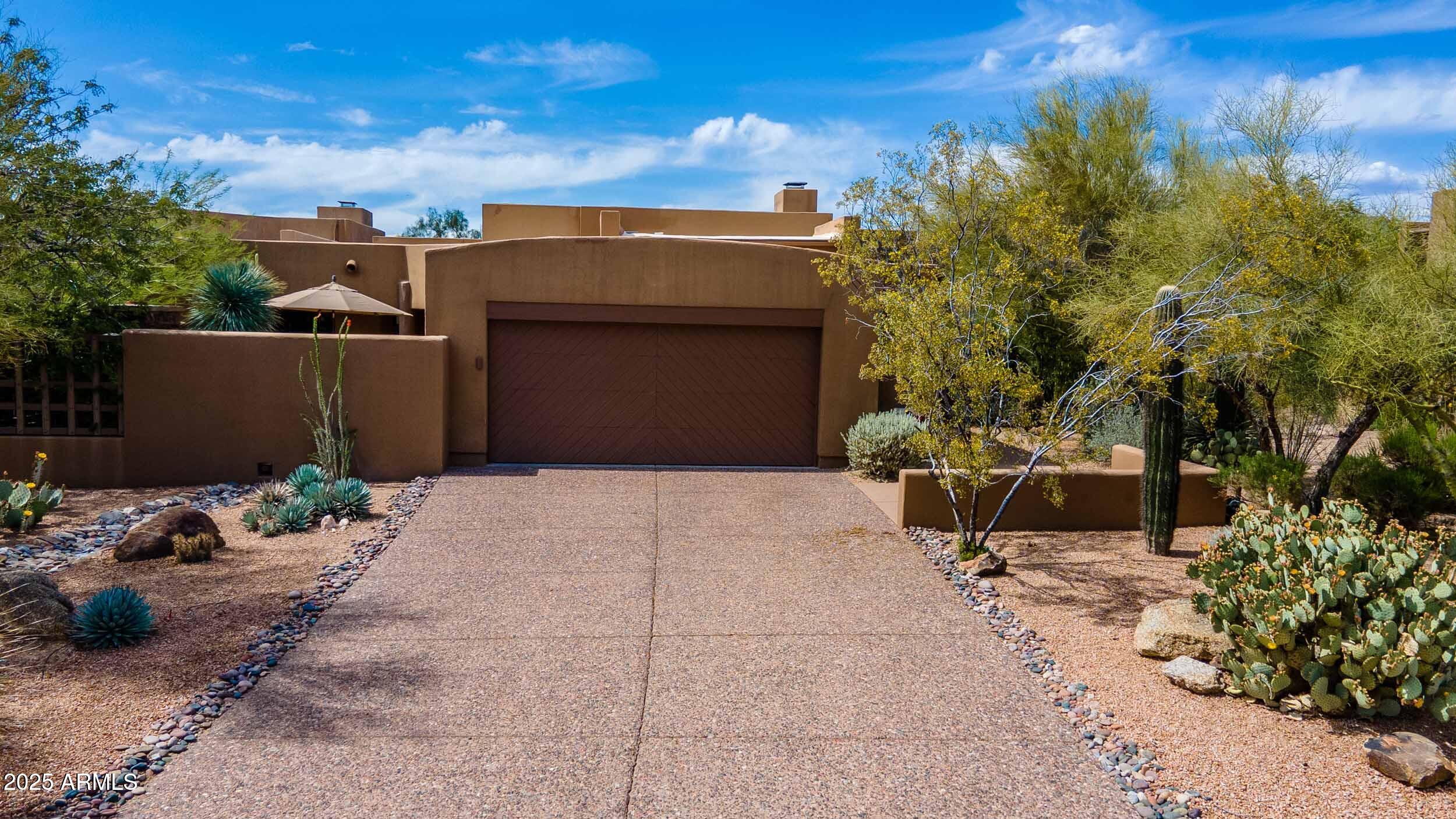 8502 East Cave Creek Road, Unit 61 Carefree, AZ 85377 - Photo 5 of 52 a view of a chair and table in the backyard