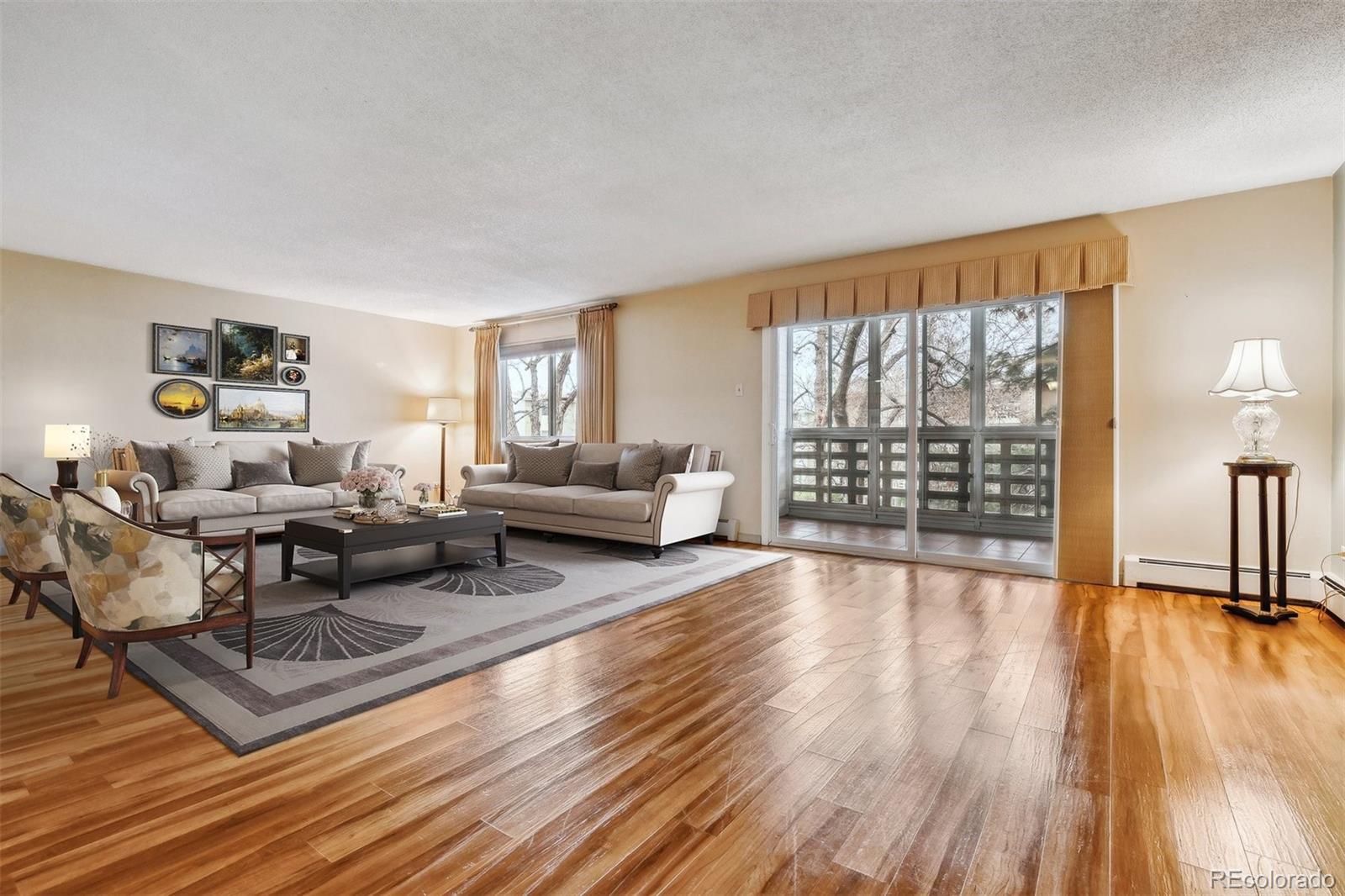 350 South Clinton Street, Unit 9C Denver, CO 80247 - Photo 1 of 28 a living room with furniture and a wooden floor