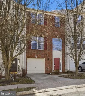 a front view of a building with trees