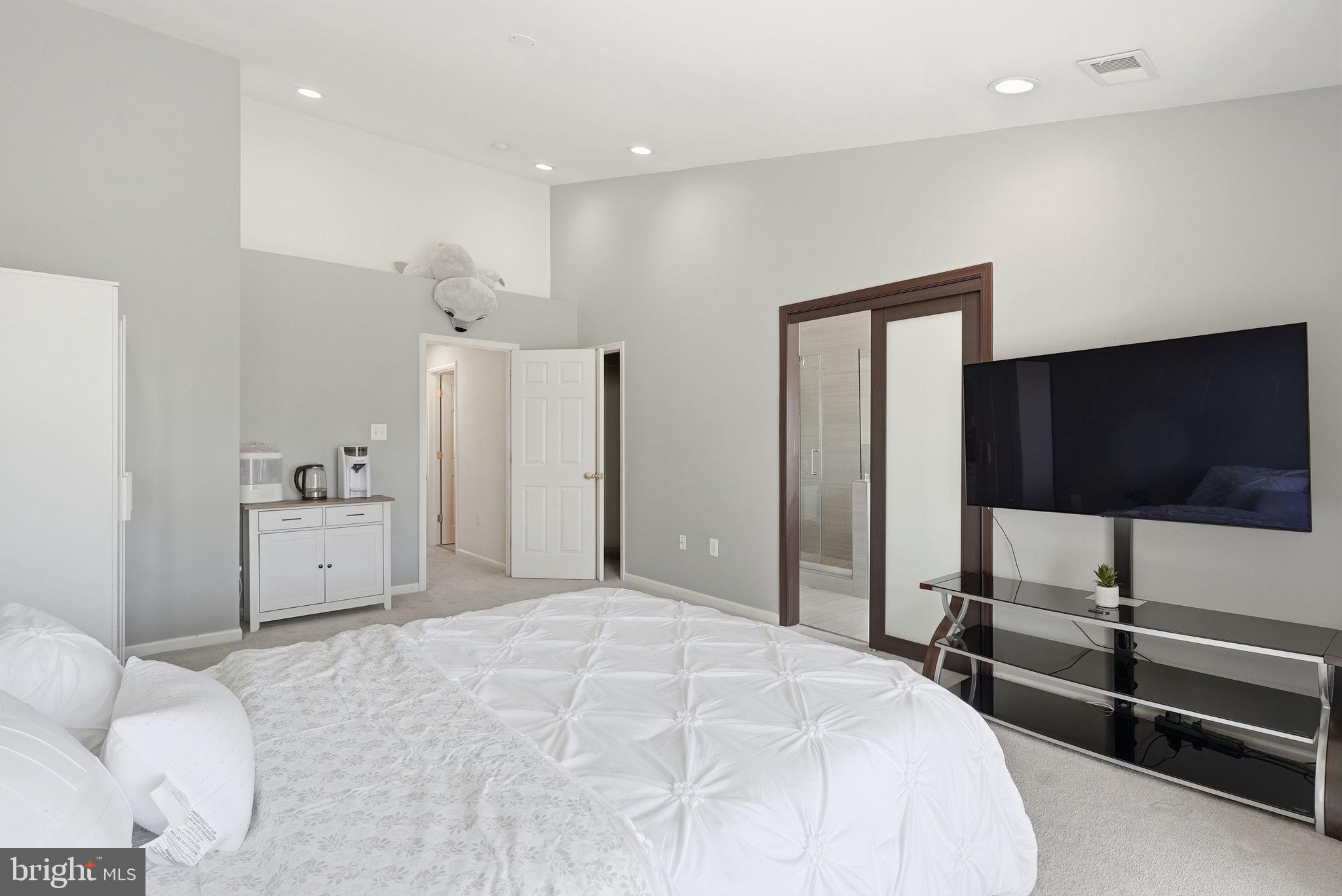 14231 Hunters Run Way Gainesville, VA 20155 - Photo 19 of 41 a bedroom with a bed and a flat screen tv