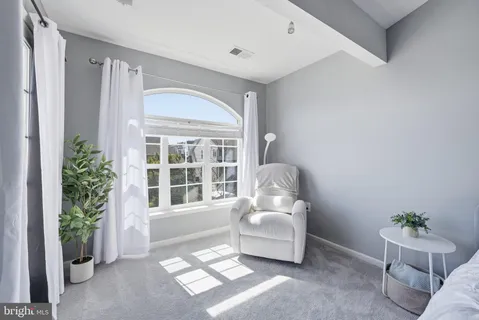 a living room with furniture and windows