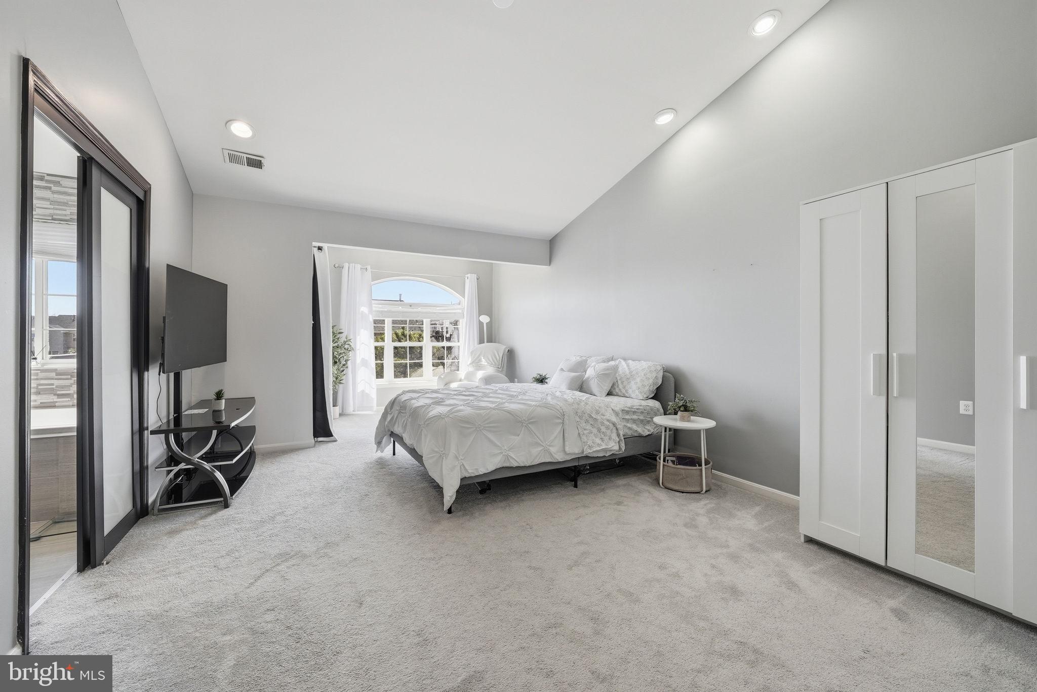 14231 Hunters Run Way Gainesville, VA 20155 - Photo 2 of 41 a bedroom with a bed and large mirror in it