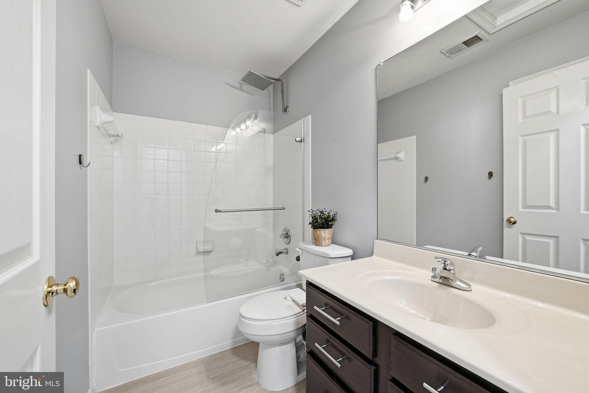 14231 Hunters Run Way Gainesville, VA 20155 - Photo 27 of 41 a bathroom with a sink a toilet a mirror and shower