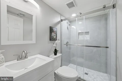a bathroom with a sink toilet and shower