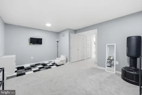 a room with furniture and gym equipment