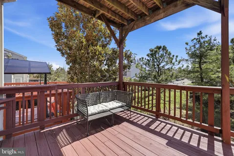 a view of a roof deck with wooden floor and fence