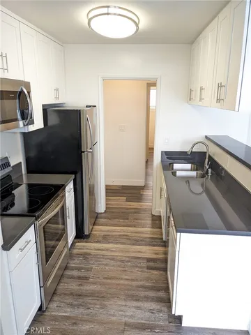 a kitchen with a sink stove and refrigerator