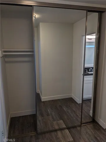 a view of walk in closet with empty racks
