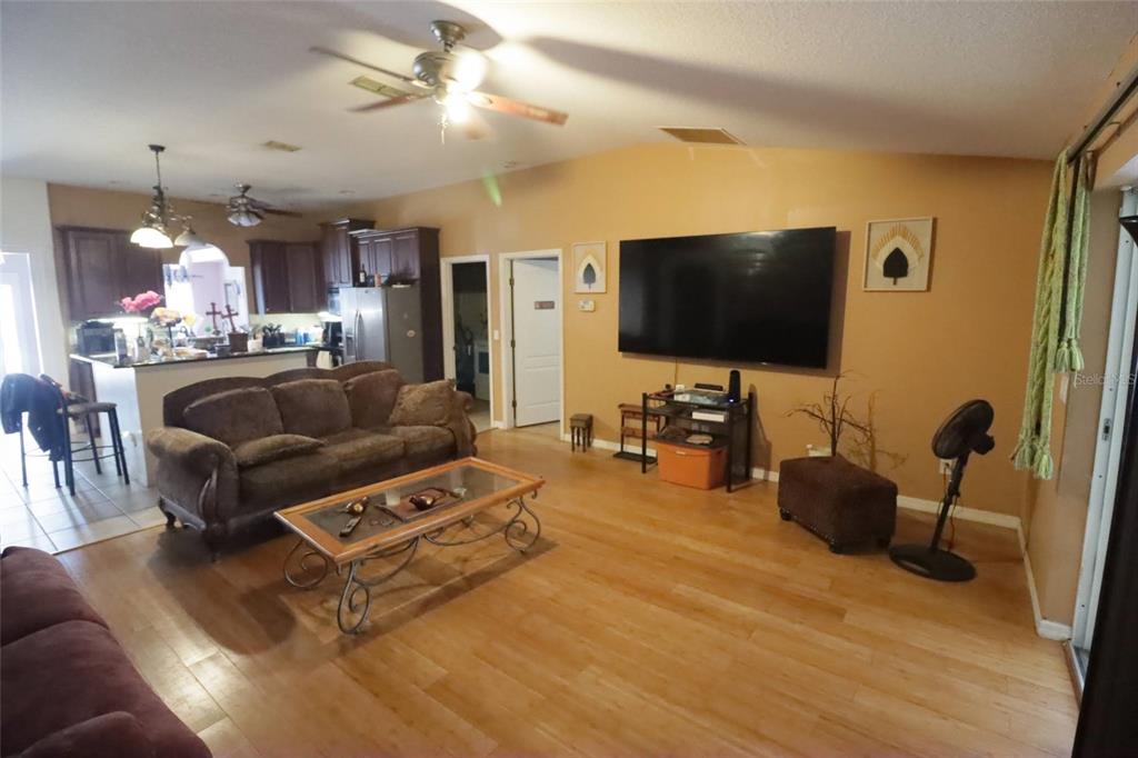 396 Kettering Road Deltona, FL 32725 - Photo 9 of 25 a living room with furniture and a flat screen tv