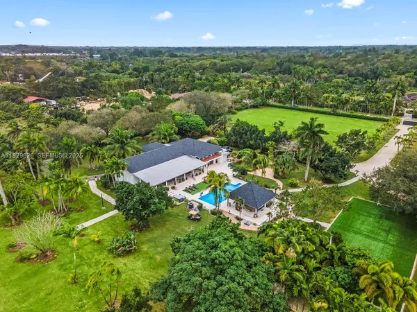 an aerial view of a house with a yard